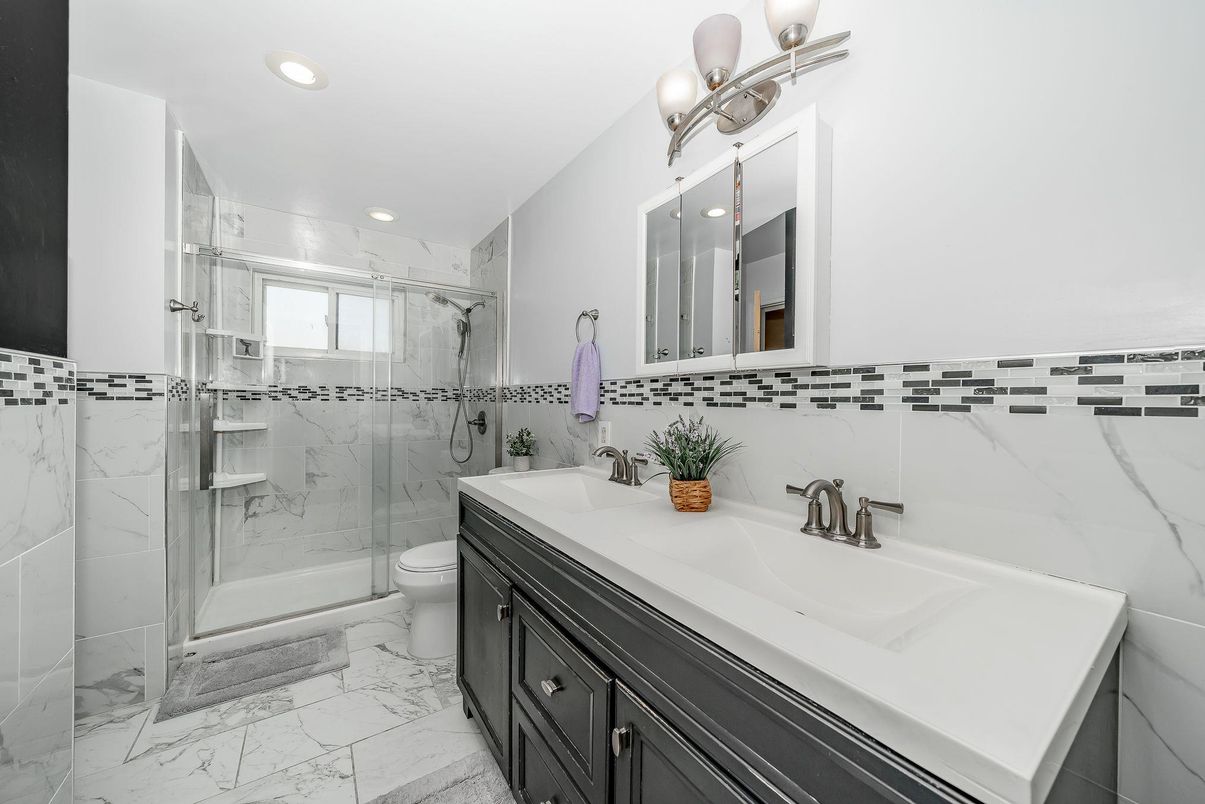 Bathroom, Dual Sink Vanities, Glass Shower, Interior, Marble, Marble Walls, Recessed Lighting
