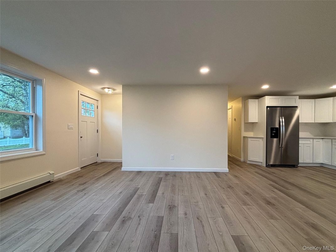 Empty room, Interior, Kitchen, Recessed Lighting, Stainless Steel Appliances, Wood Texture Flooring