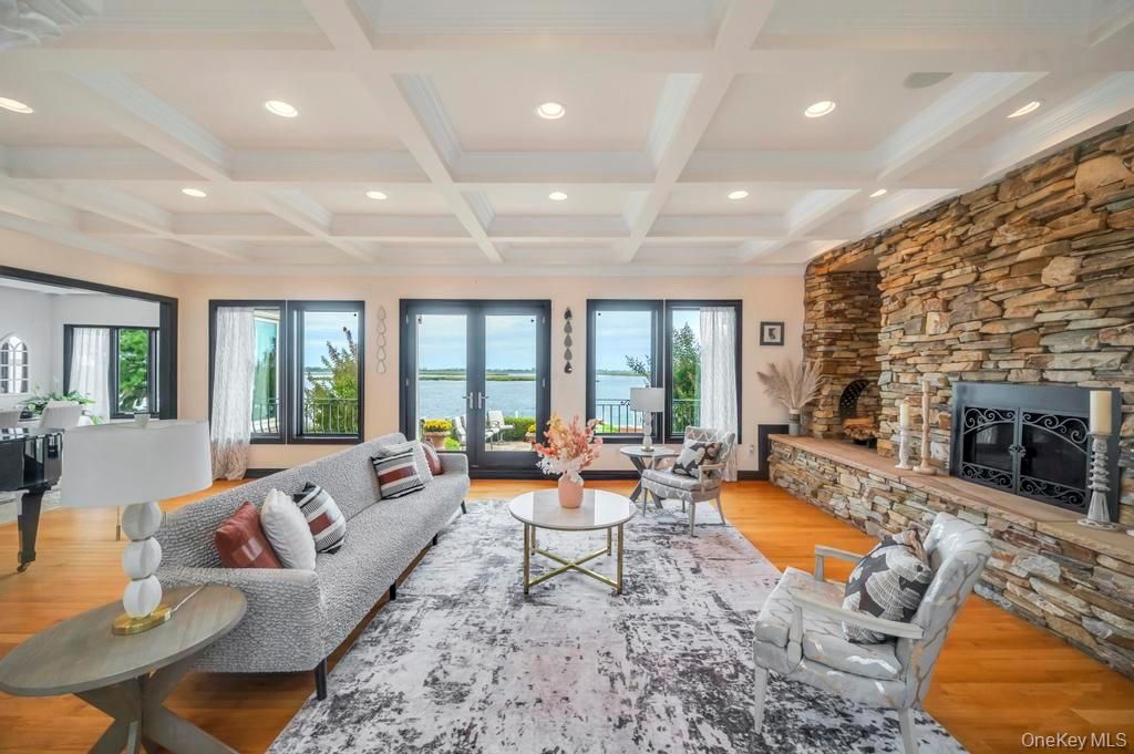 Fireplace, Interior, Living room, Recessed Lighting, Stone Walls, Water, Wood Texture Flooring