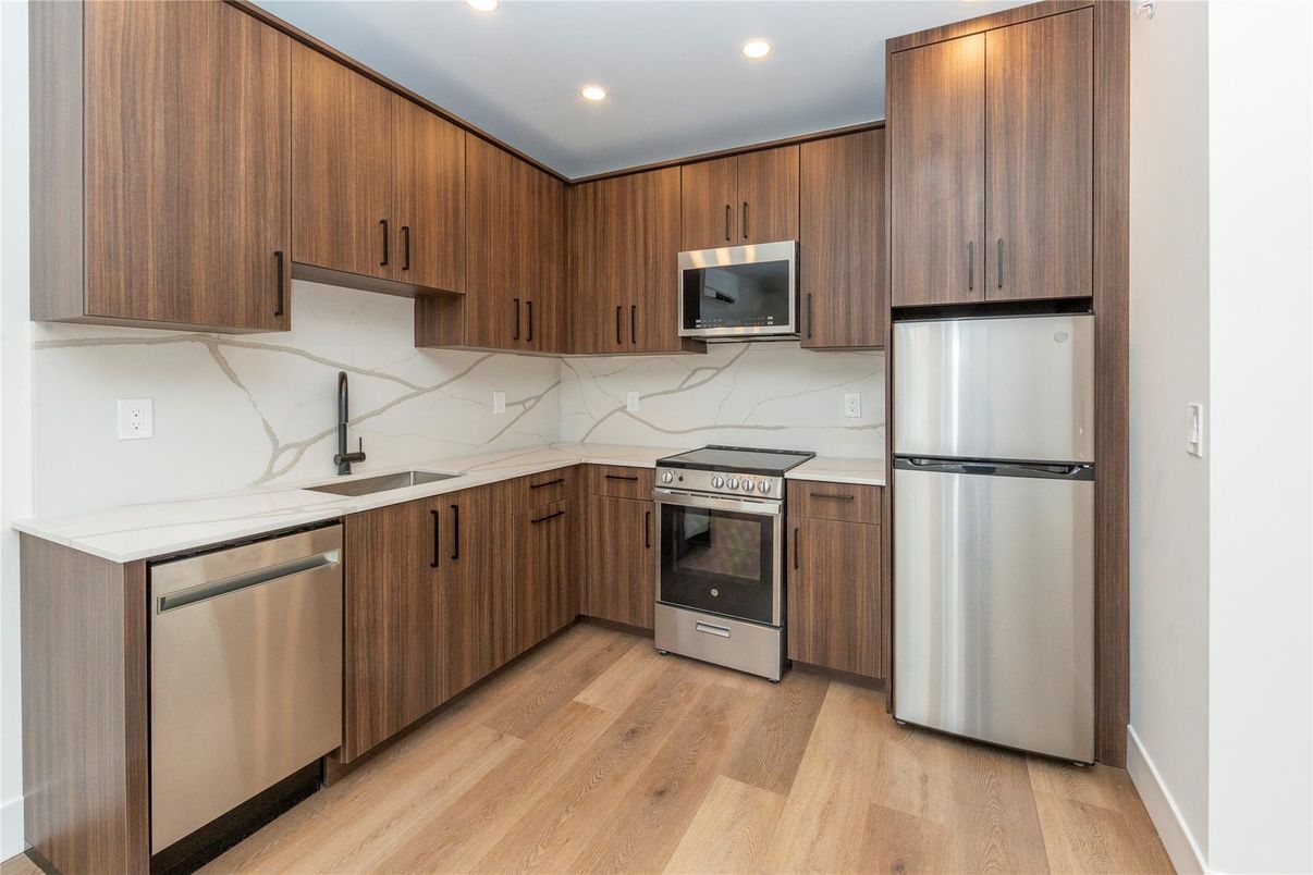 Interior, Kitchen, Marble Walls, Recessed Lighting, Stainless Steel Appliances, Wood Texture Flooring