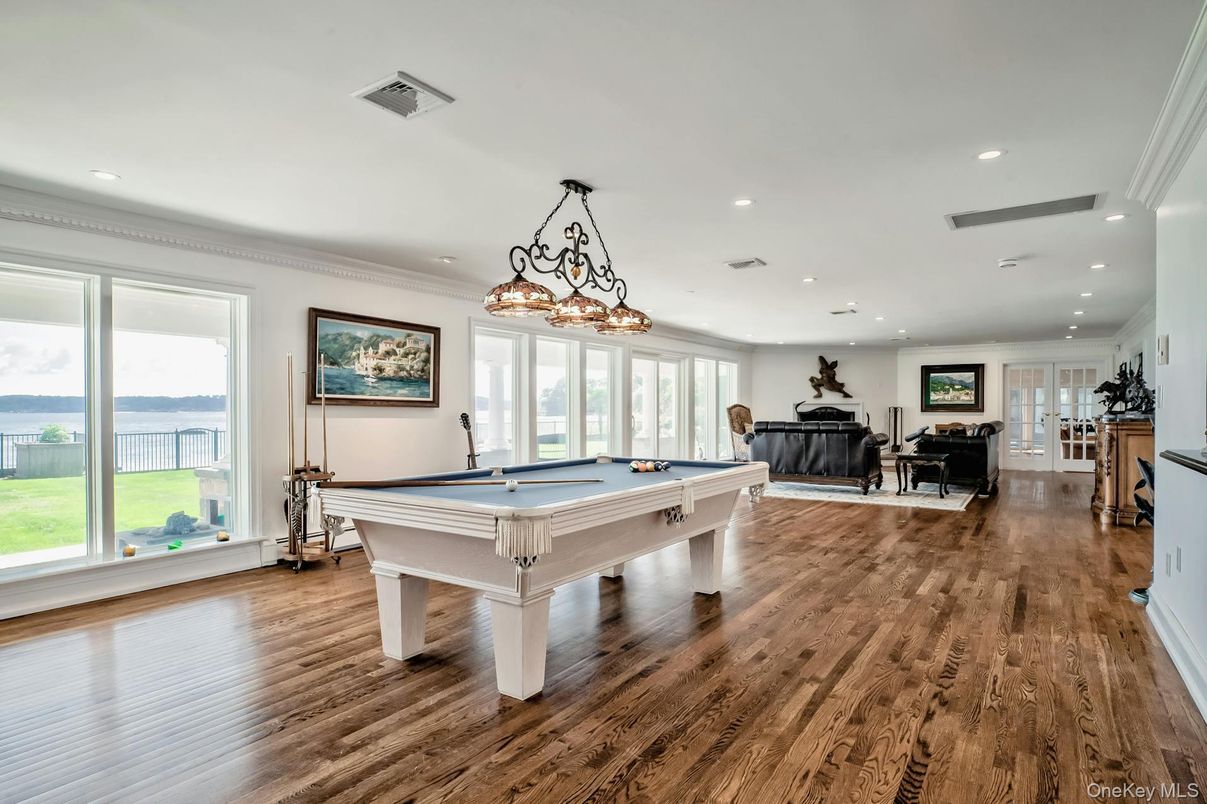 Billiard Table, Chandelier, Fireplace, Game Room, Interior, Pendant Lights, Recessed Lighting, Water, Wood Texture Flooring
