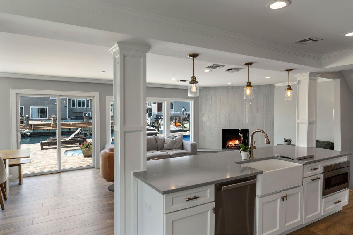 Fireplace, Interior, Kitchen, Living room, Pendant Lights, Recessed Lighting, Stainless Steel Appliances, Wood Texture Flooring