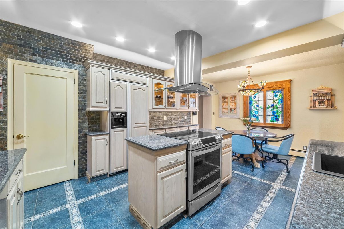 Chandelier, Dining room, Interior, Kitchen, Pendant Lights, Recessed Lighting, Stainless Steel Appliances, Stone Walls