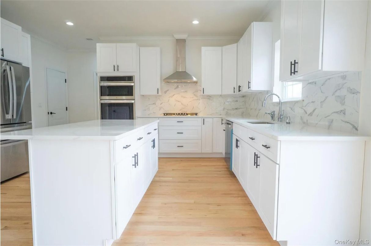 Interior, Kitchen, Marble Walls, Recessed Lighting, Stainless Steel Appliances, Wood Texture Flooring