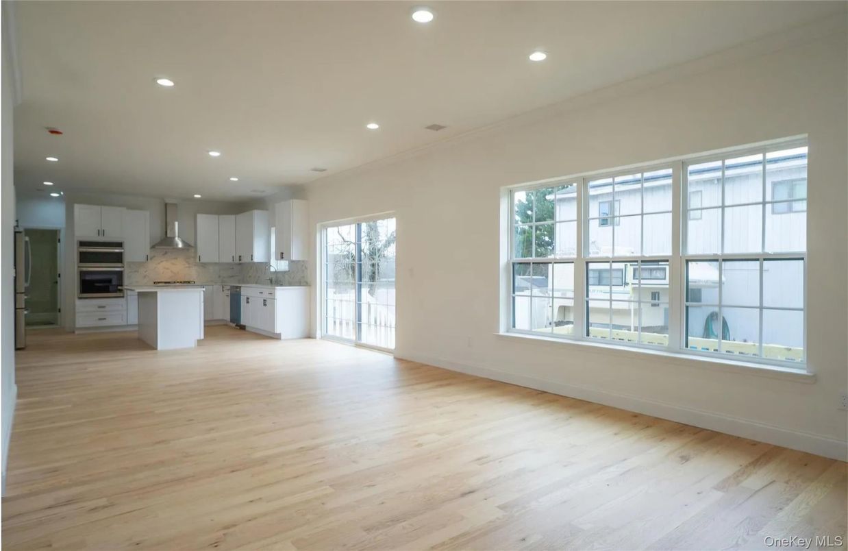 Empty room, Interior, Kitchen, Recessed Lighting, Stainless Steel Appliances, Wood Texture Flooring