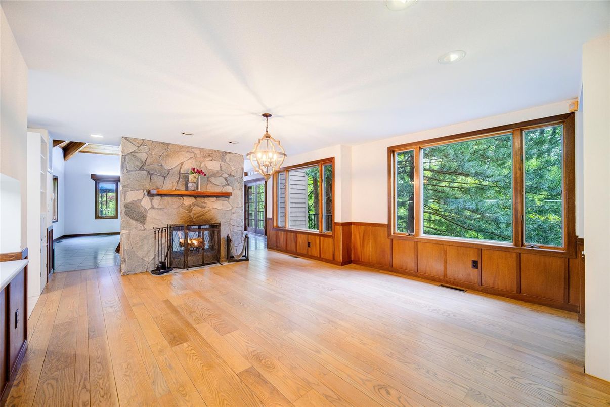 Chandelier, Empty room, Fireplace, Interior, Recessed Lighting, Stone Walls, Wood Texture Flooring