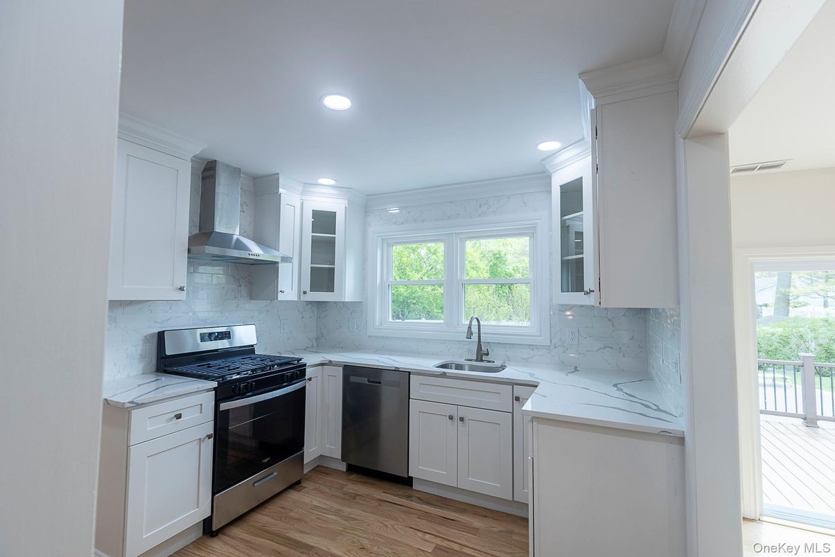 Interior, Kitchen, Marble Walls, Recessed Lighting, Stainless Steel Appliances, Wood Texture Flooring