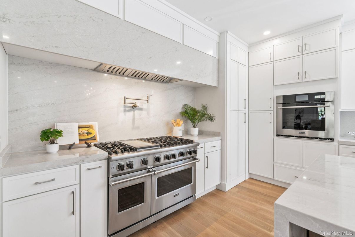 Interior, Kitchen, Marble Walls, Recessed Lighting, Stainless Steel Appliances, Wood Texture Flooring