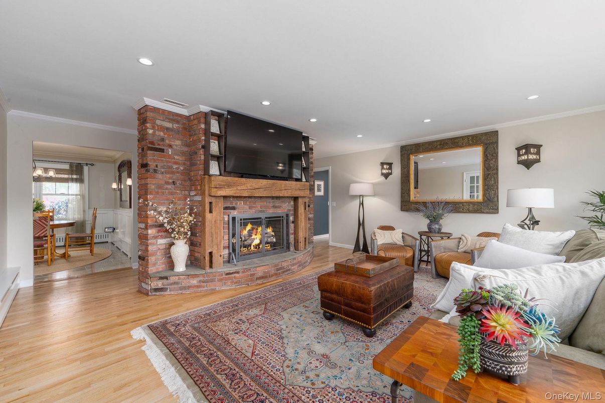 Dining room, Fireplace, Interior, Living room, Recessed Lighting, Stone Walls, Wood Texture Flooring