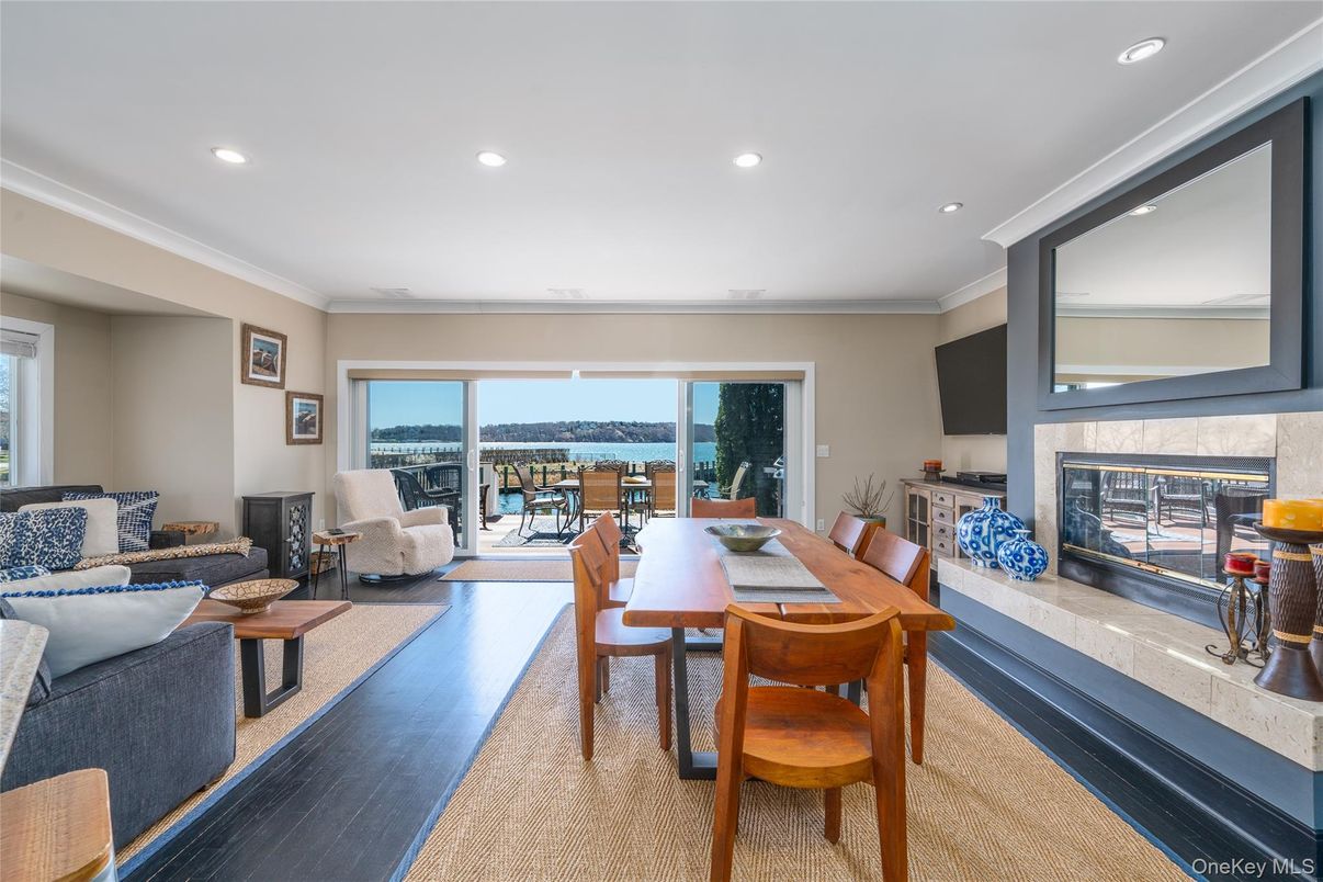 Dining room, Fireplace, Interior, Living room, Recessed Lighting, Water, Wood Texture Flooring