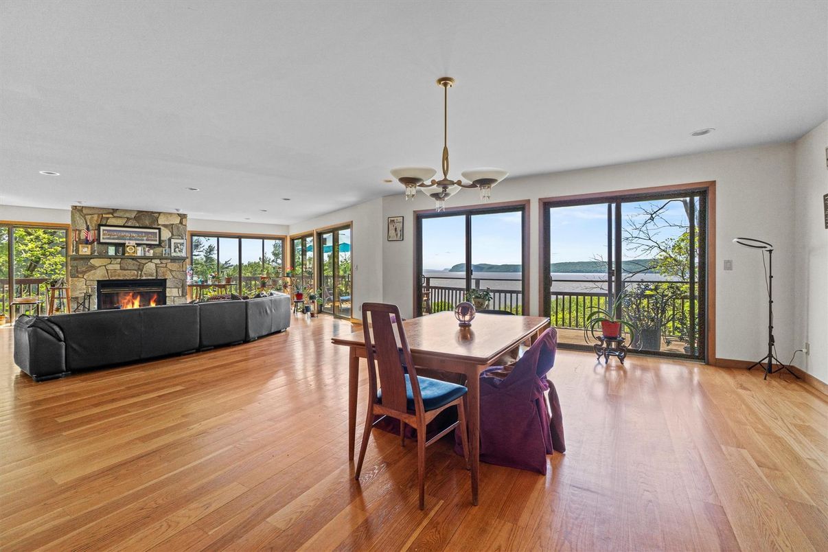 Dining room, Fireplace, Interior, Living room, Recessed Lighting, Water, Wood Texture Flooring