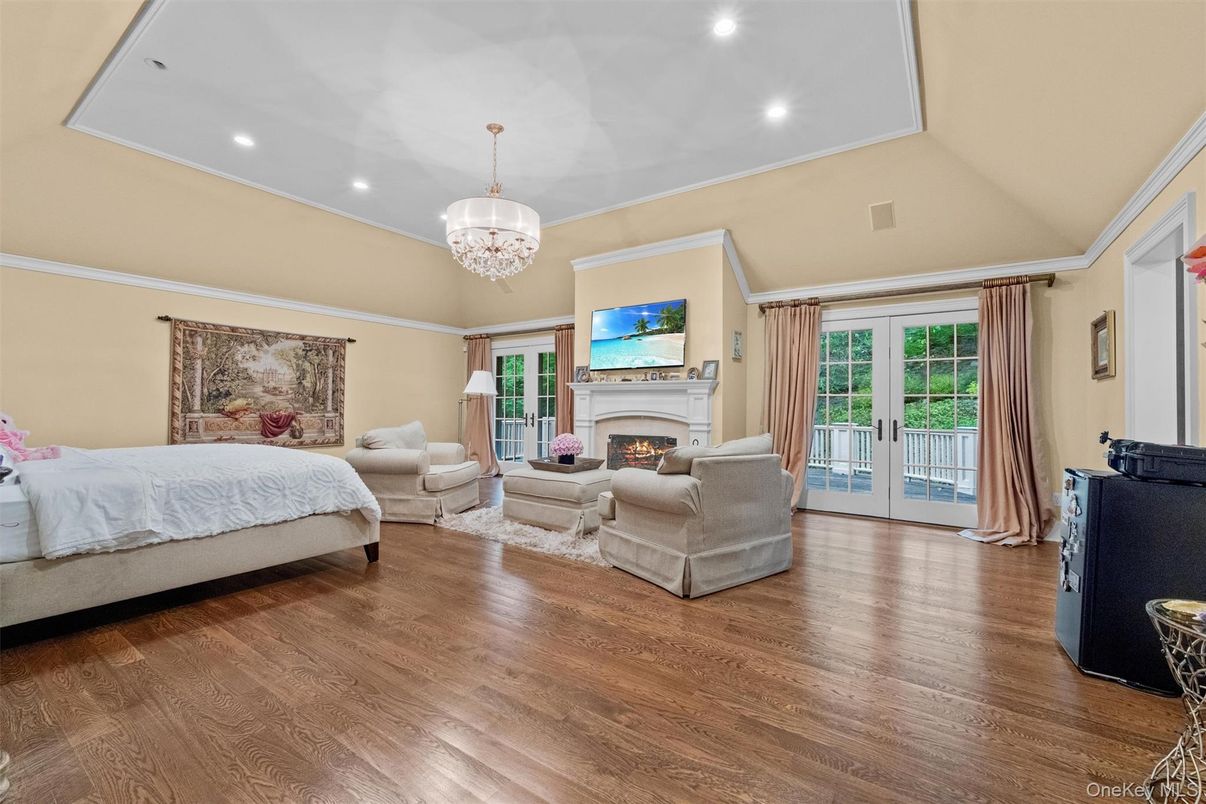 Bedroom, Chandelier, Fireplace, Interior, Recessed Lighting, Wood Texture Flooring