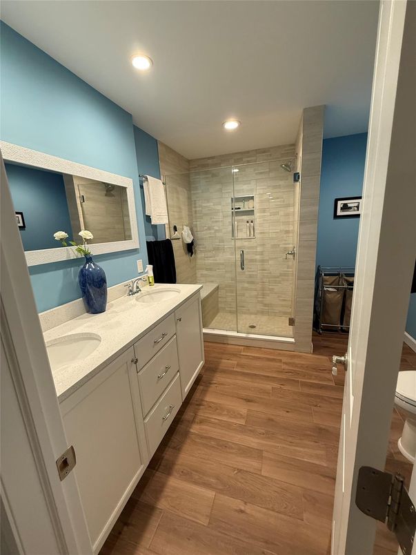 Bathroom, Dual Sink Vanities, Glass Shower, Interior, Recessed Lighting, Wood Texture Flooring
