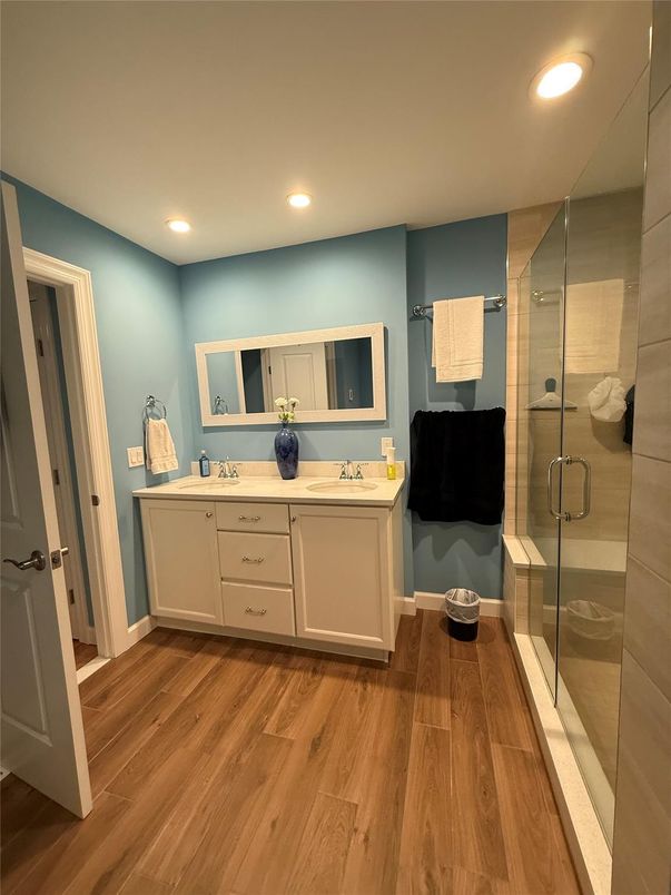 Bathroom, Dual Sink Vanities, Glass Shower, Interior, Recessed Lighting, Wood Texture Flooring