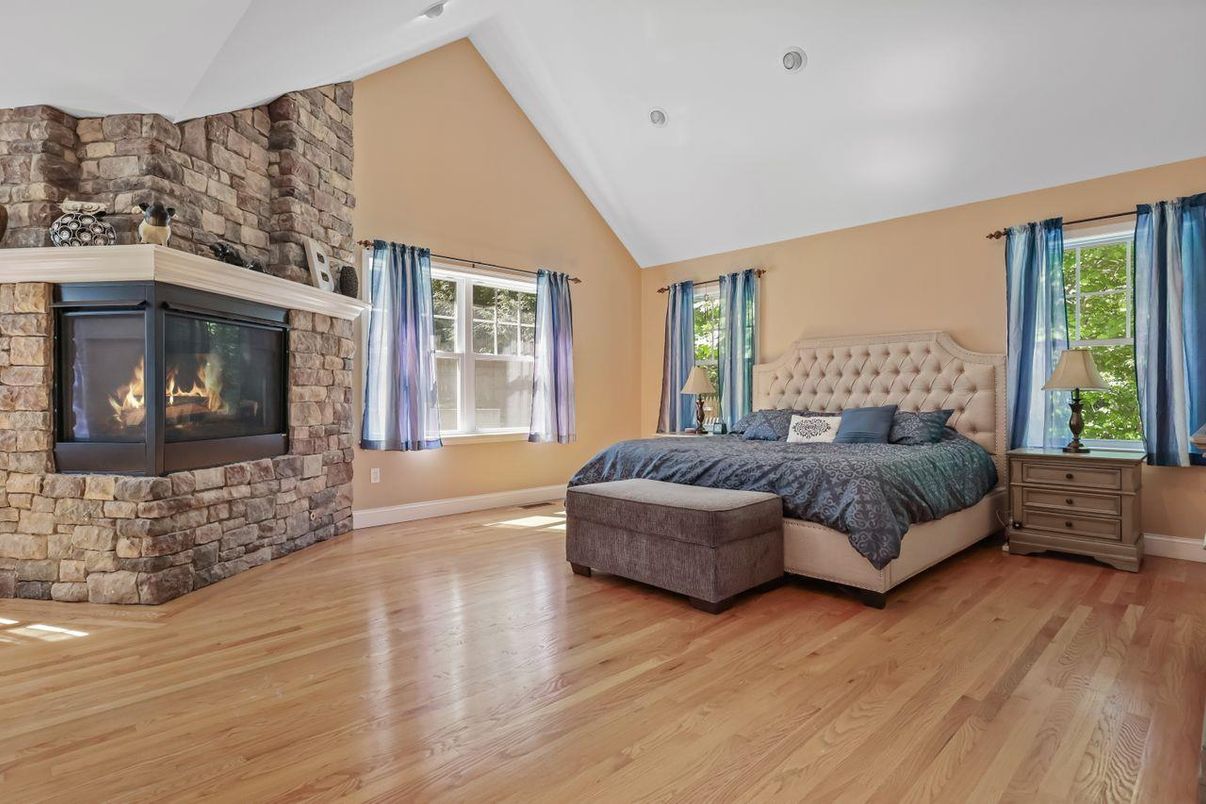 Bedroom, Fireplace, Interior, Recessed Lighting, Stone Walls, Wood Texture Flooring