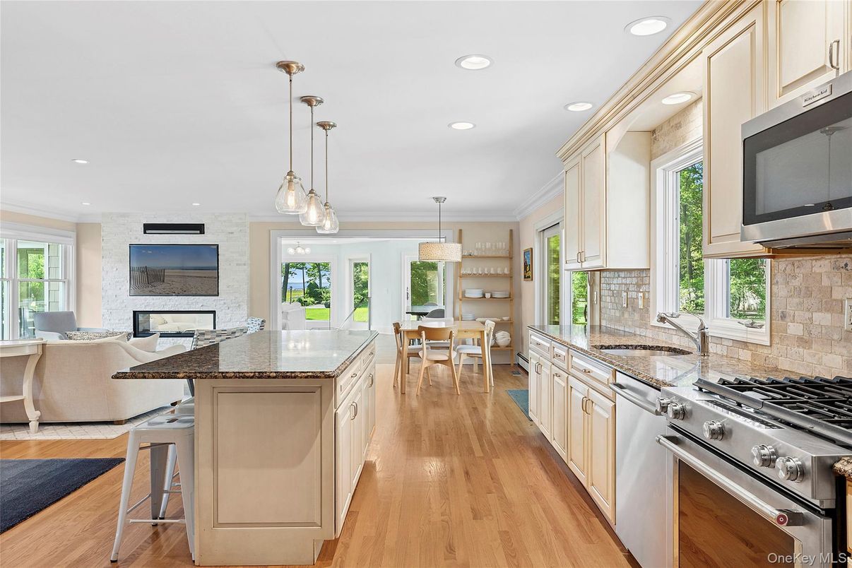 Chandelier, Dining room, Interior, Kitchen, Living room, Pendant Lights, Recessed Lighting, Stainless Steel Appliances, Stone Walls, Wood Texture Flooring