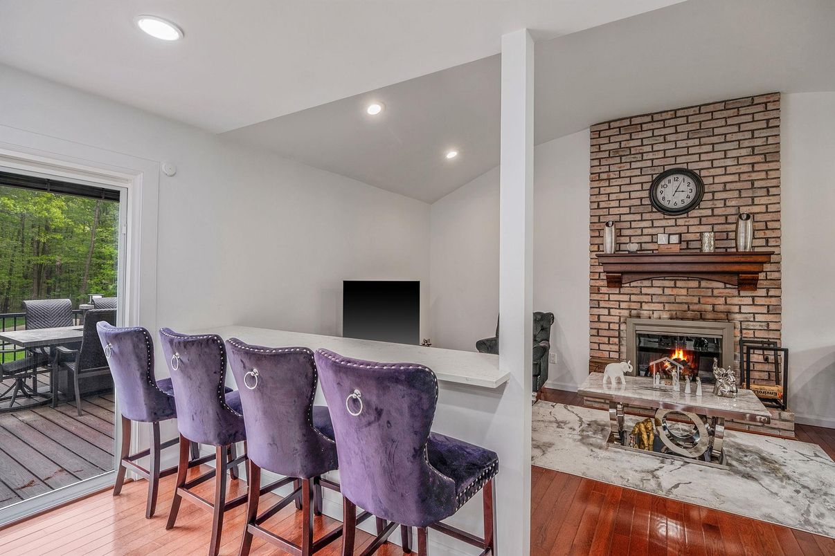 Dining room, Fireplace, Interior, Recessed Lighting, Stone Walls, Wood Texture Flooring