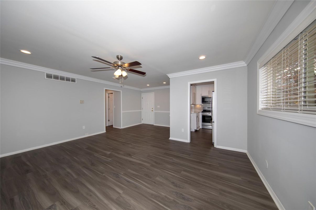 Empty room, Interior, Kitchen, Recessed Lighting, Stainless Steel Appliances, Wood Texture Flooring