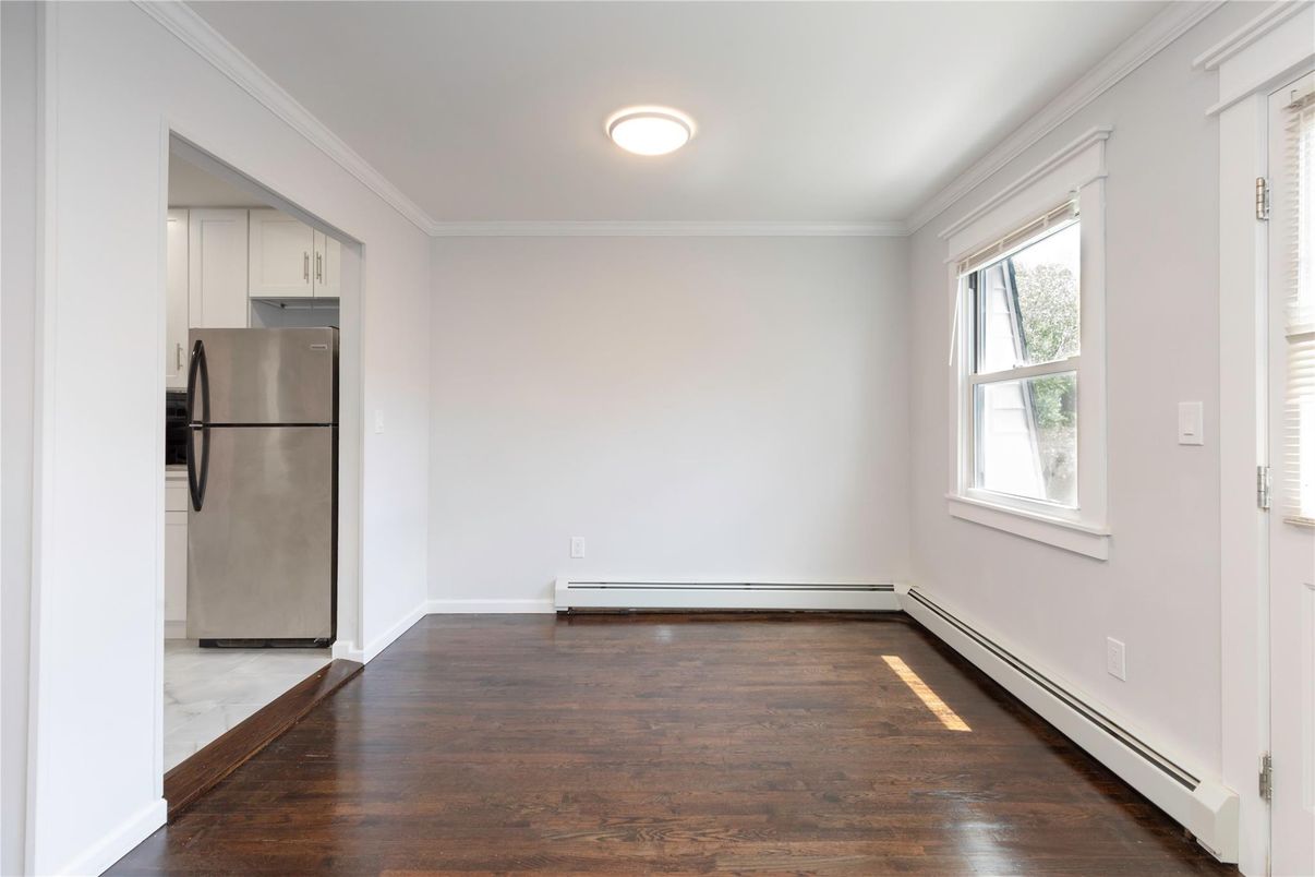 Empty room, Interior, Kitchen, Recessed Lighting, Stainless Steel Appliances, Wood Texture Flooring