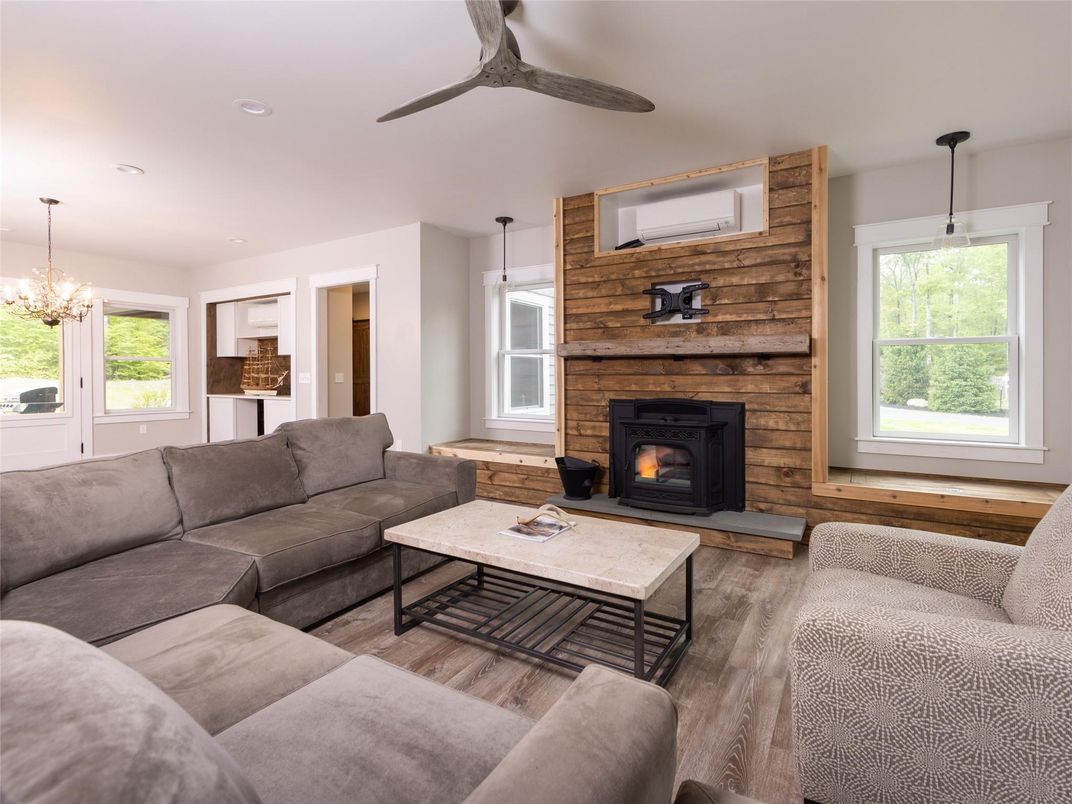 Chandelier, Fireplace, Interior, Living room, Pendant Lights, Recessed Lighting, Stone Walls, Wood Texture Flooring, Wooden Walls
