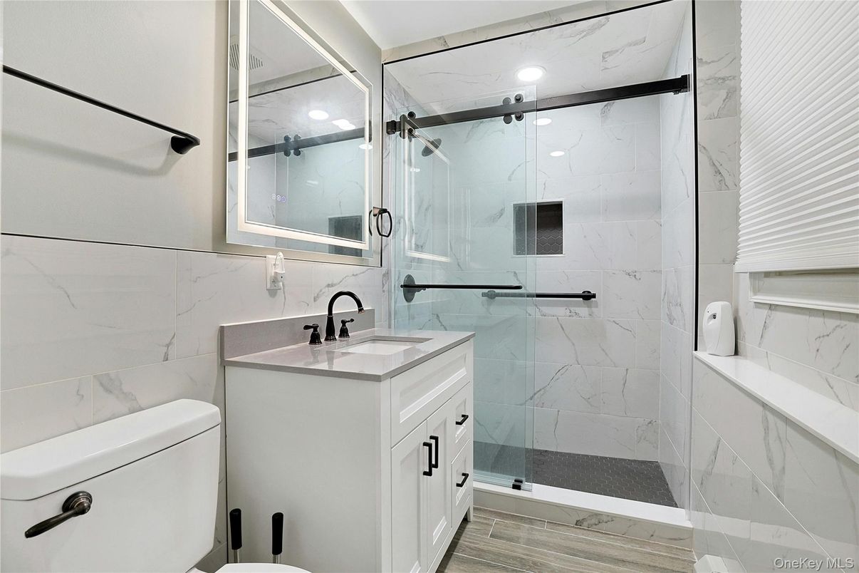 Bathroom, Glass Shower, Interior, Marble Walls, Recessed Lighting, Wood Texture Flooring