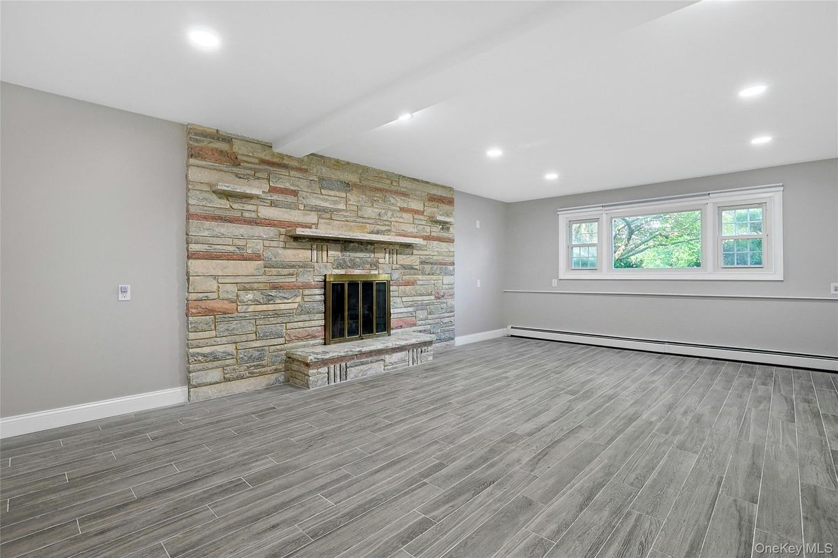 Empty room, Fireplace, Interior, Recessed Lighting, Stone Walls, Wood Texture Flooring