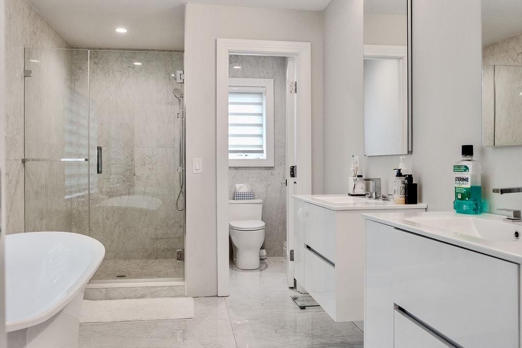 Bathroom, Dual Sink Vanities, Glass Shower, Interior, Marble, Marble Walls, Recessed Lighting