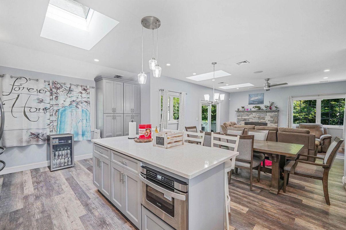 Dining room, Fireplace, Interior, Kitchen, Living room, Pendant Lights, Recessed Lighting, Stainless Steel Appliances, Wood Texture Flooring