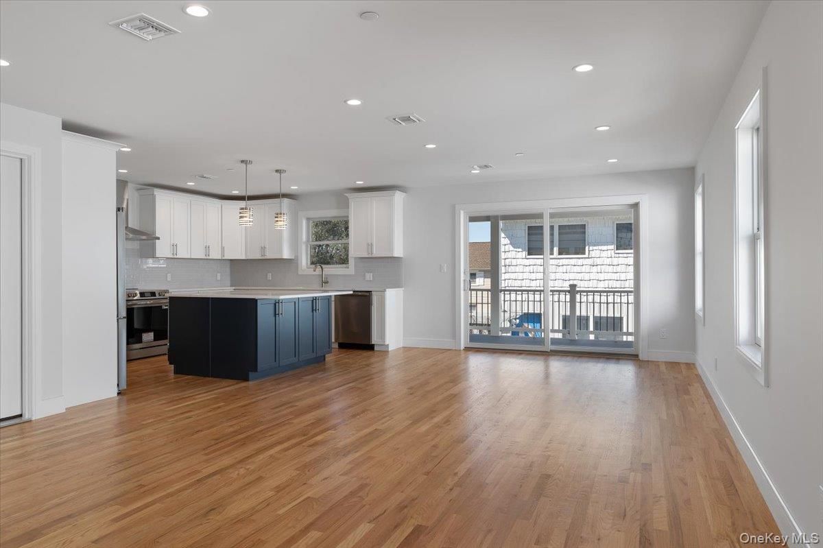 Empty room, Interior, Kitchen, Pendant Lights, Recessed Lighting, Stainless Steel Appliances, Wood Texture Flooring