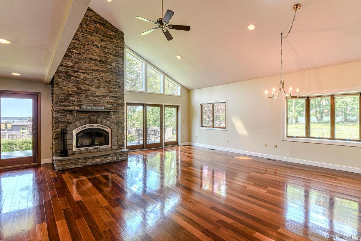 Chandelier, Empty room, Fireplace, Interior, Recessed Lighting, Stone Walls, Wood Texture Flooring