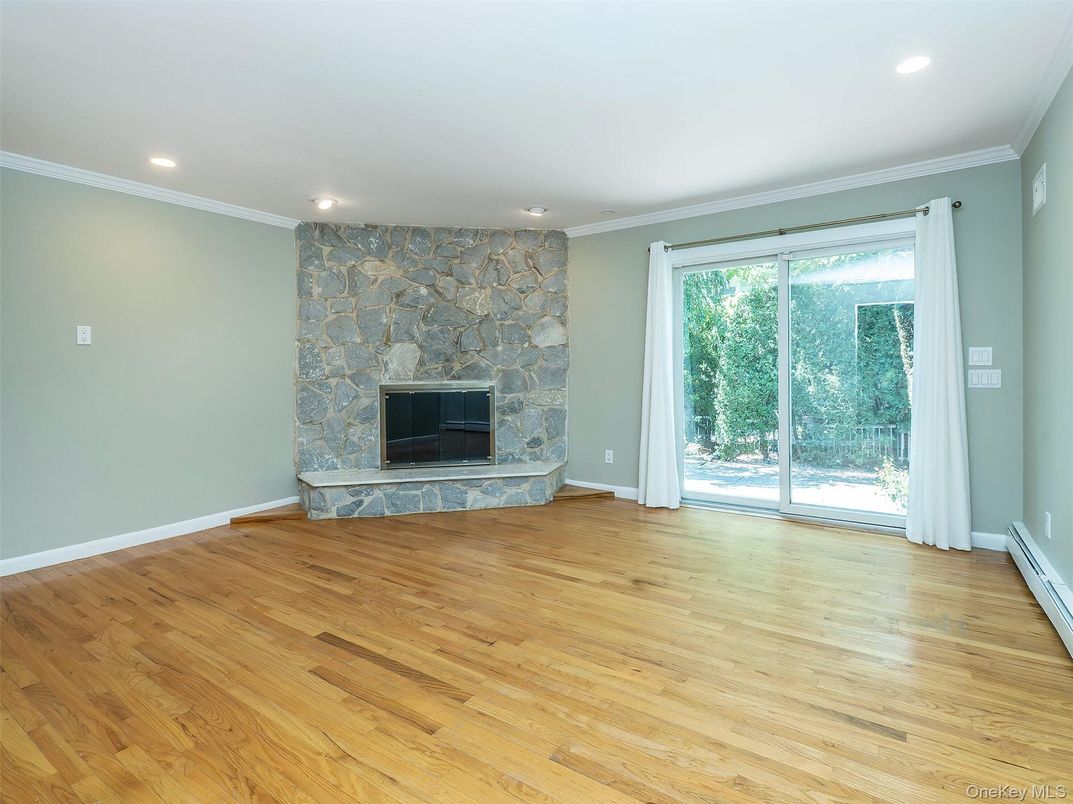 Empty room, Fireplace, Interior, Recessed Lighting, Stone Walls, Wood Texture Flooring