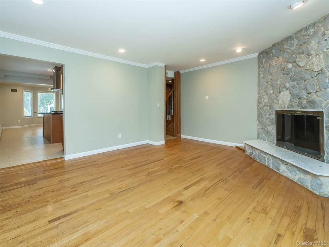 Empty room, Fireplace, Interior, Recessed Lighting, Stone Walls, Wood Texture Flooring