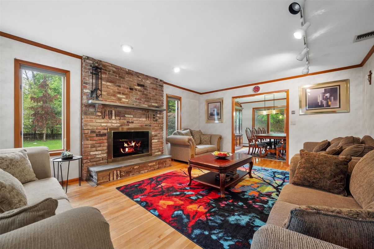 Dining room, Fireplace, Interior, Living room, Recessed Lighting, Stone Walls, Wood Texture Flooring