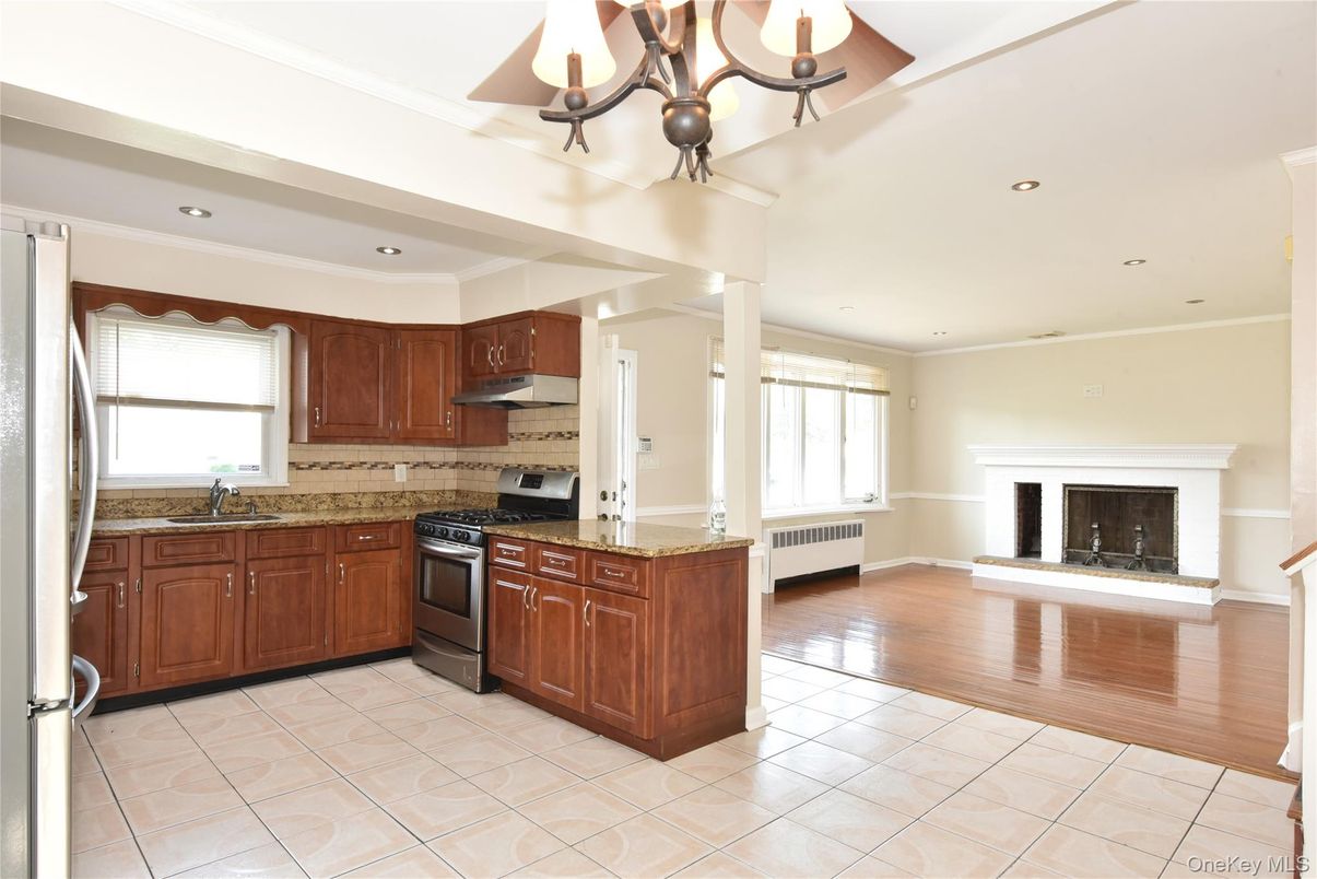 Chandelier, Fireplace, Interior, Kitchen, Recessed Lighting, Stainless Steel Appliances, Wood Texture Flooring