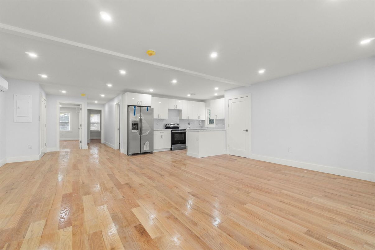 Empty room, Interior, Kitchen, Recessed Lighting, Stainless Steel Appliances, Wood Texture Flooring