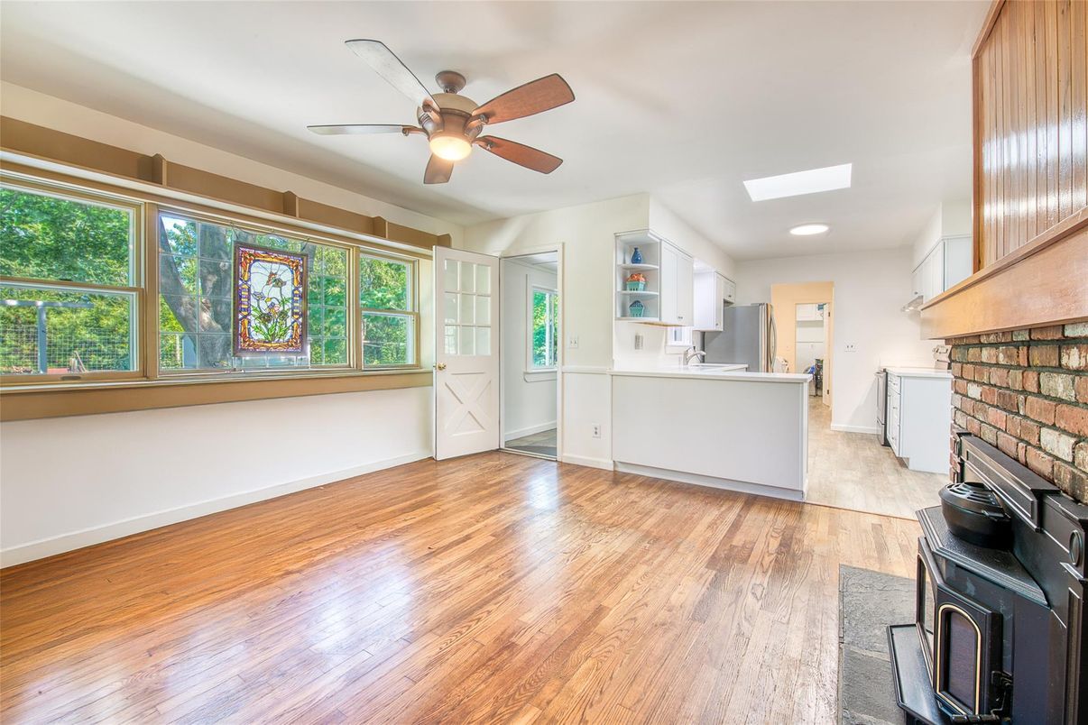 Empty room, Fireplace, Interior, Kitchen, Recessed Lighting, Stone Walls, Wood Texture Flooring