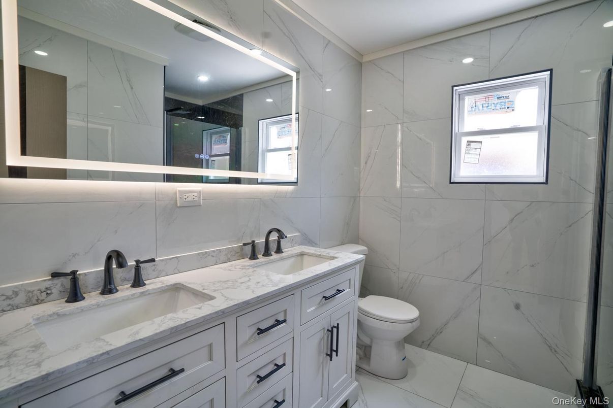 Bathroom, Dual Sink Vanities, Glass Shower, Interior, Marble, Marble Walls, Recessed Lighting