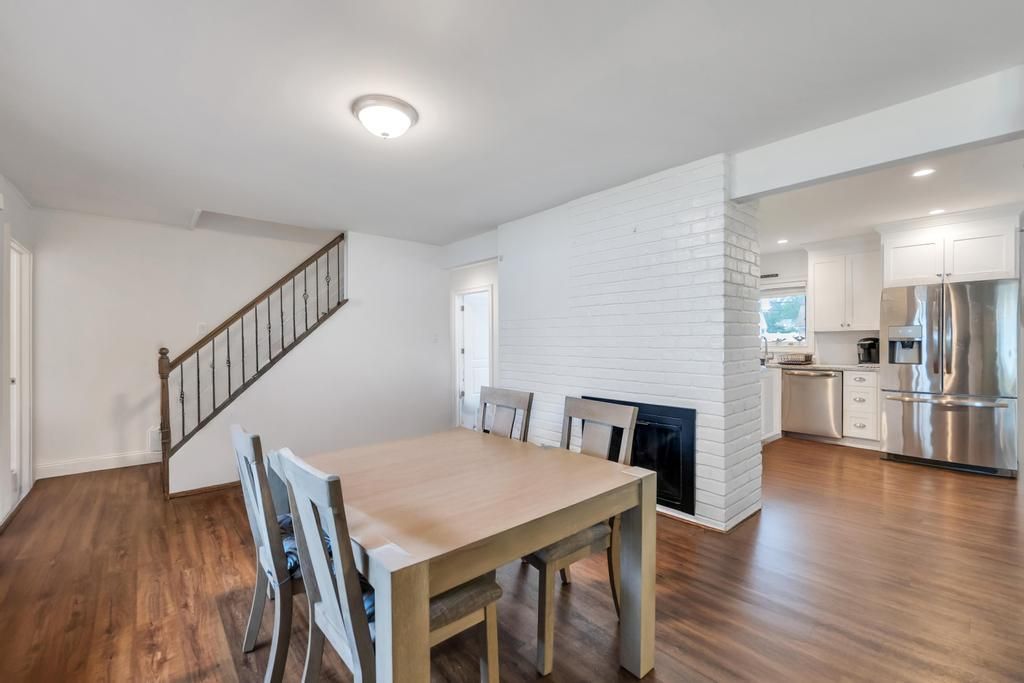 Dining room, Fireplace, Interior, Kitchen, Recessed Lighting, Stainless Steel Appliances, Stone Walls, Wood Texture Flooring