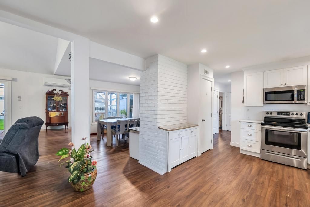 Dining room, Interior, Kitchen, Recessed Lighting, Stainless Steel Appliances, Stone Walls, Wood Texture Flooring