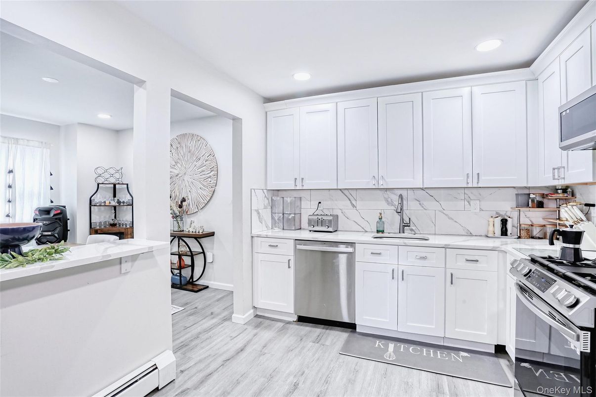 Interior, Kitchen, Marble Walls, Recessed Lighting, Stainless Steel Appliances, Wood Texture Flooring