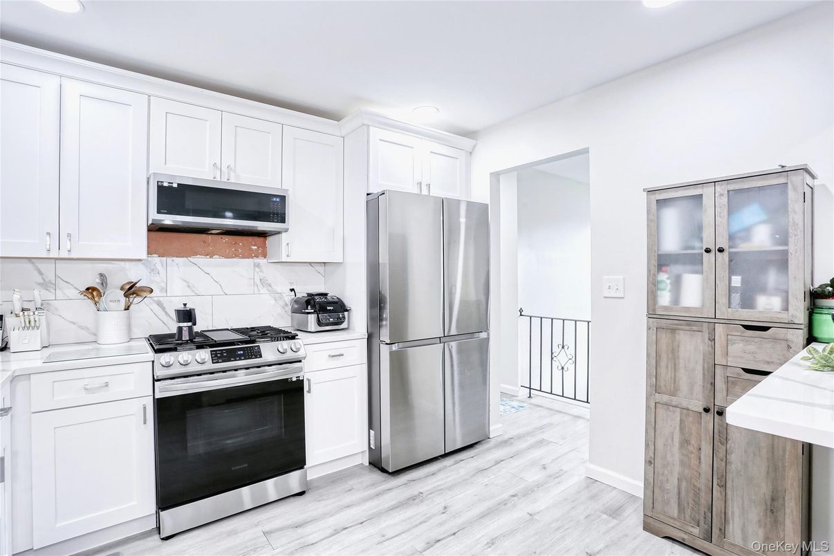 Interior, Kitchen, Marble Walls, Recessed Lighting, Stainless Steel Appliances, Wood Texture Flooring