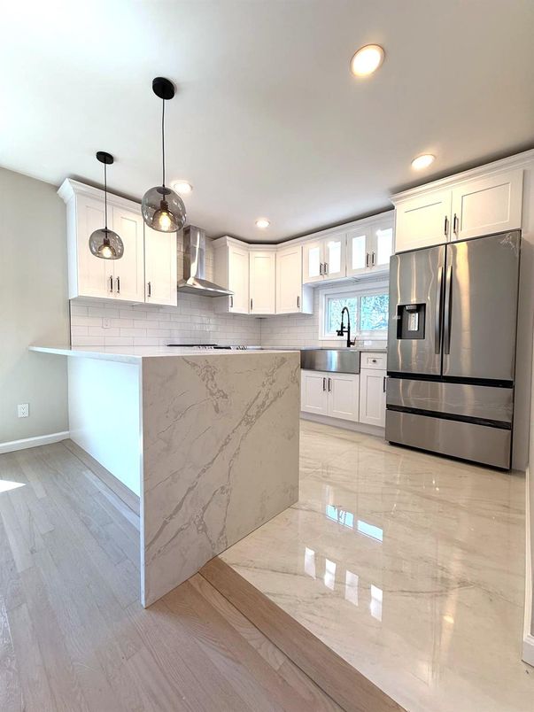 Interior, Kitchen, Marble, Marble Walls, Pendant Lights, Recessed Lighting, Stainless Steel Appliances, Wood Texture Flooring
