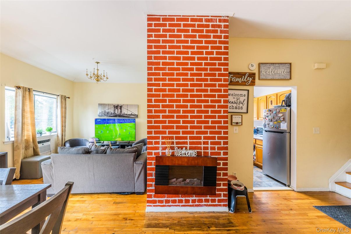 Chandelier, Fireplace, Interior, Living room, Stone Walls, Wood Texture Flooring