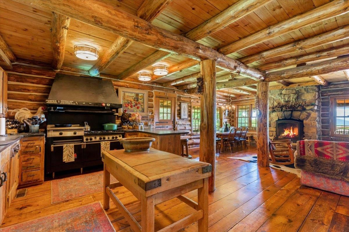 Chandelier, Dining room, Fireplace, Interior, Kitchen, Stainless Steel Appliances, Wooden Beams, Wooden Ceilings, Wood Texture Flooring, Wooden Walls