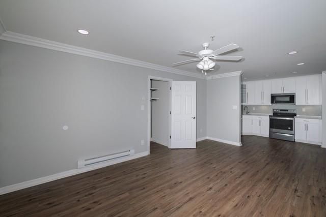 Empty room, Interior, Kitchen, Recessed Lighting, Stainless Steel Appliances, Wood Texture Flooring