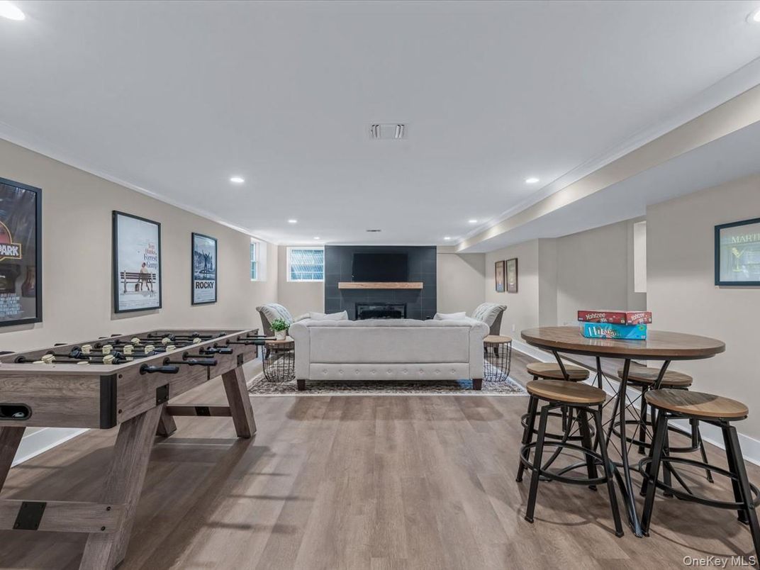 Dining room, Fireplace, Game Room, Interior, Living room, Recessed Lighting, Wood Texture Flooring