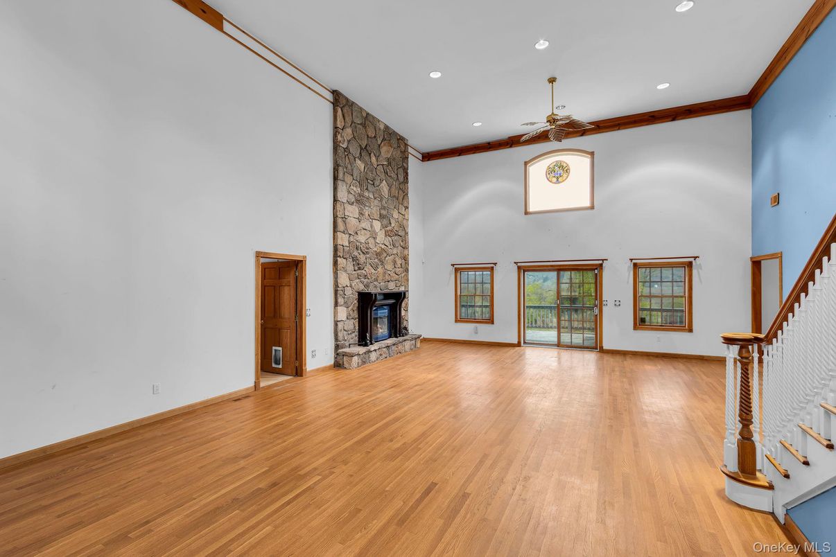 Empty room, Fireplace, Interior, Recessed Lighting, Stone Walls, Wood Texture Flooring