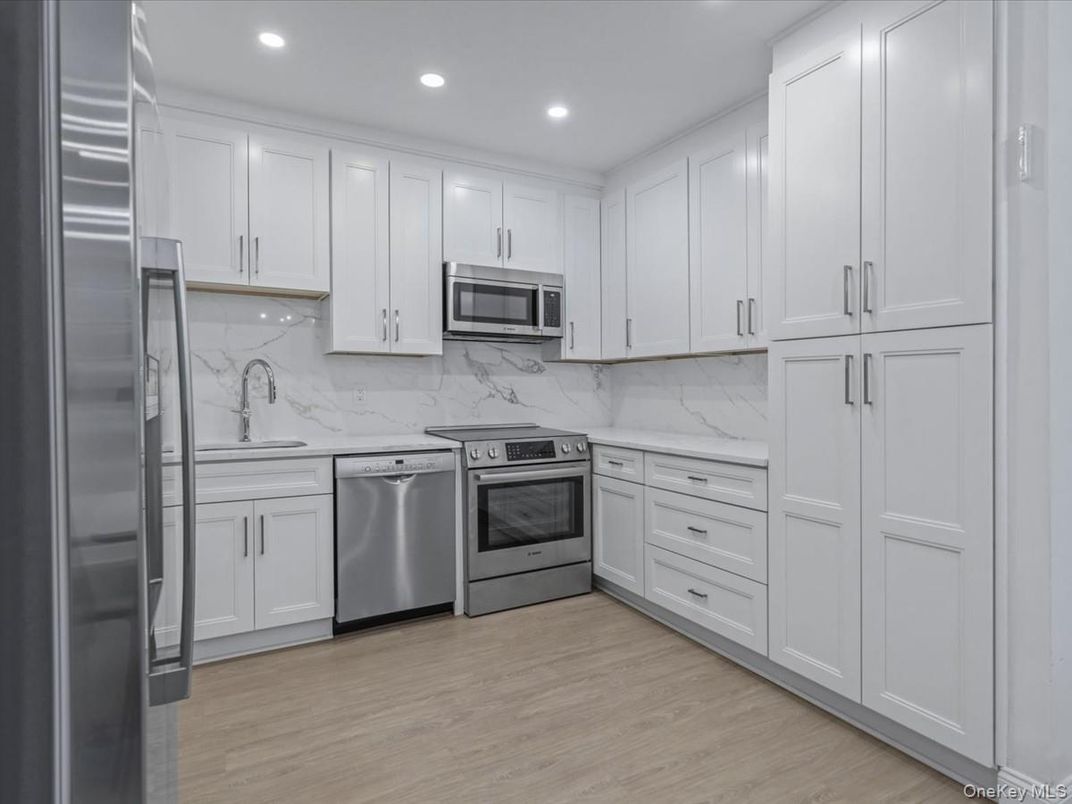 Interior, Kitchen, Marble Walls, Recessed Lighting, Stainless Steel Appliances, Wood Texture Flooring