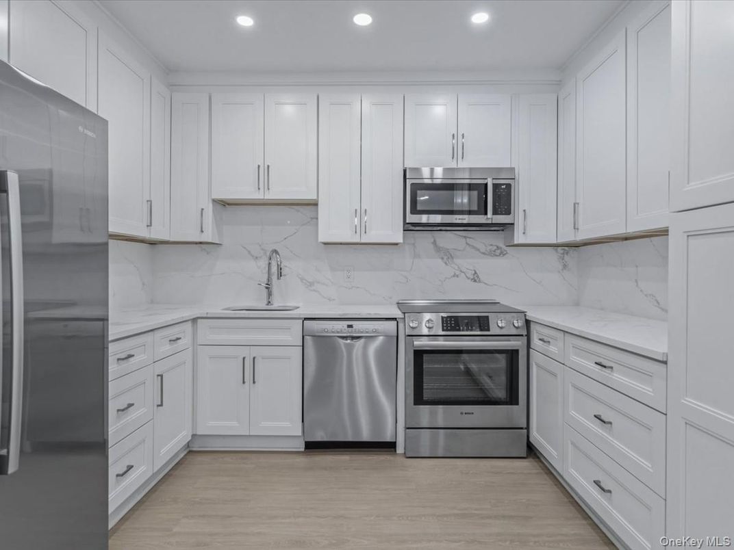 Interior, Kitchen, Marble Walls, Recessed Lighting, Stainless Steel Appliances, Wood Texture Flooring