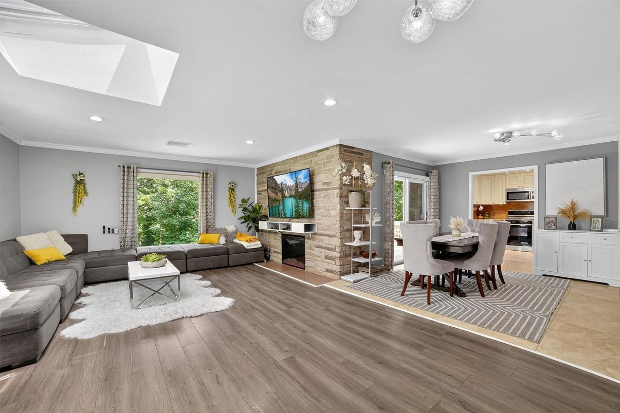 Dining room, Fireplace, Interior, Kitchen, Living room, Recessed Lighting, Stainless Steel Appliances, Stone Walls, Wood Texture Flooring